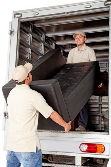 Men working for a moving services company unloading a sofa from a truck