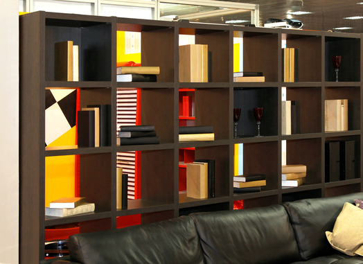 Wooden shelf with books in library interior