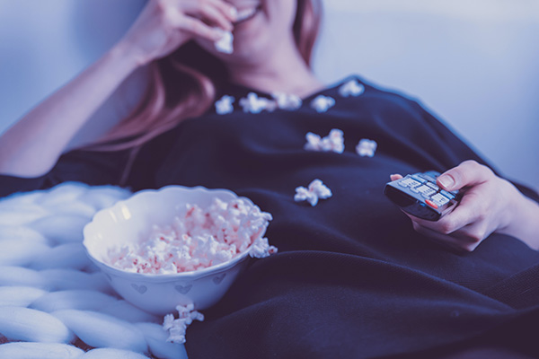 Eat popcorn and snacks while watching a movie 